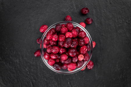 Portion of healthy Dried Cranberries on a slate slab (selective focus)の写真素材