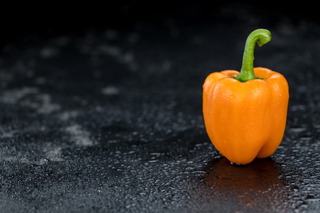 Slate slab with Orange paprika (selective focus; close-up shot)の写真素材