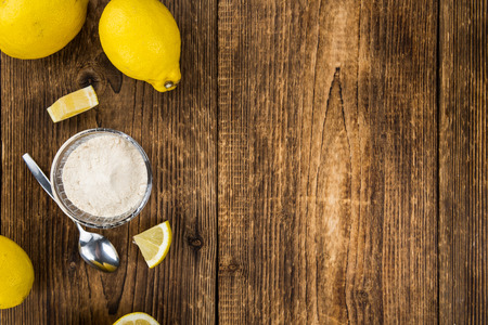 Vintage wooden table with Lemon powder (selective focus; close-up shot)の写真素材