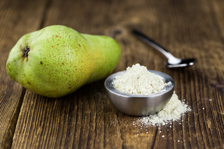 Some Pear powder on a vintage wooden table (selective focus; close-up shot)の写真素材