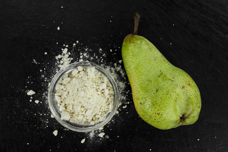 Fresh made Pear powder on a slate slab (close-up shot; selective focus)の写真素材