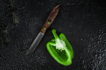 Paprika (green) on a vintage looking slate slab (selective focus)の写真素材