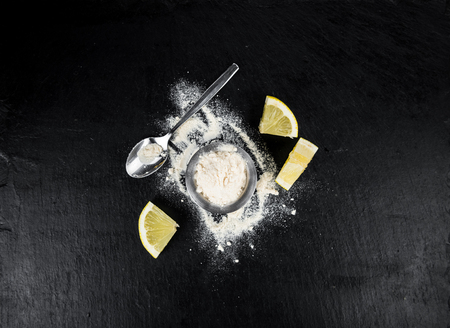 Portion of healthy Lemon powder on a slate slab (selective focus)の写真素材