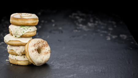 Some fresh made white chocolate Donuts (selective focus; close-up shot)の写真素材