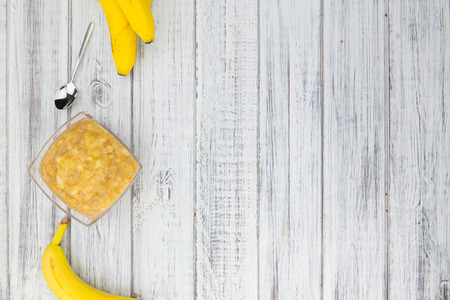 Banana Puree on wooden background (selective focus; close-up shot)の写真素材