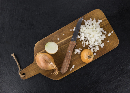 Portion of Chopped white onions as detailed close up shot on a slate slab; selective focusの写真素材