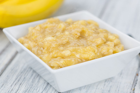 Mashed Bananas (selective focus; close-up shot) on a vintage backgroundの写真素材