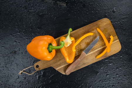 Fresh made Orange paprika on a slate slab (close-up shot; selective focus)の写真素材
