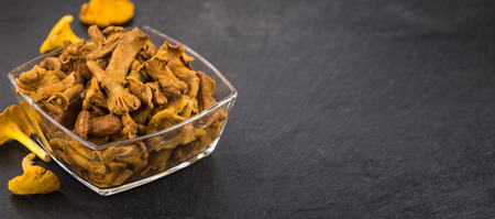 Portion of Preserved chanterelles as detailed close up shot on a slate slab; selective focusの写真素材