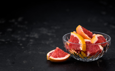 Chopped Grapefruits (selective focus) on a vintage background as detailed close-up shotの写真素材