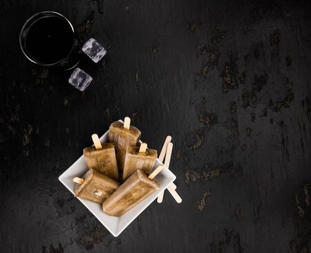 Cola ice creams (selective focus) on a vintage background as detailed close-up shotの写真素材