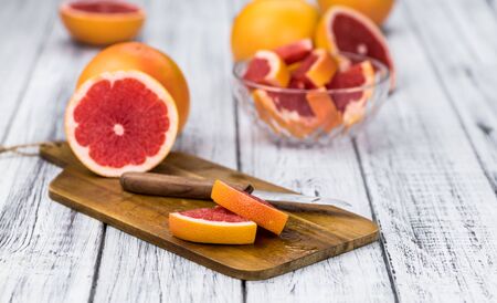Chopped Grapefruits (selective focus) on a vintage background as detailed close-up shot