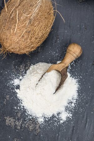 Some fresh made  Coconut flour on a vintage slate slab (selective focus)の写真素材