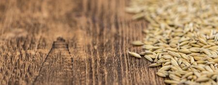 Wooden table with Oat (detailed close-up shot; selective focus)の写真素材