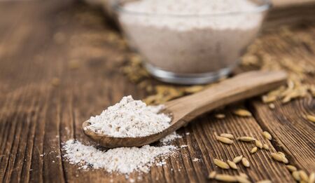 Portion of fresh Oat Flour on an old wooden tableの写真素材