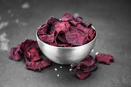 Portion of healthy Beetroot Chips on a slate slab (selective focus)の写真素材