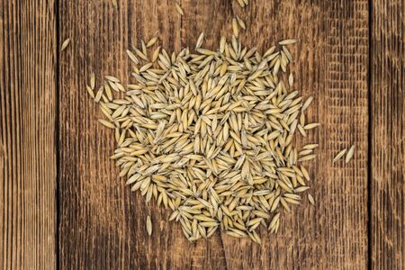 Old wooden table with fresh Oat (close-up shot; selective focus)の写真素材