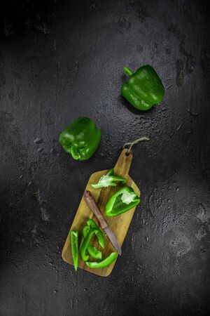 Paprika (green) on a vintage looking slate slab (selective focus)の写真素材
