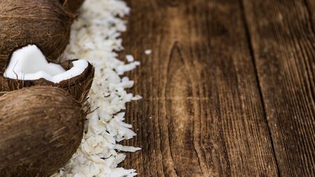 Healthy Coconut Flakes on a wooden table as detailed close-up shot (selective focus)の写真素材