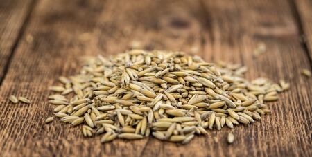 Wooden table with Oat (detailed close-up shot; selective focus)の写真素材