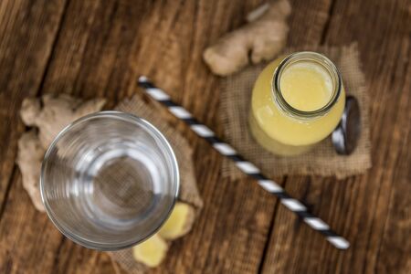 Healthy Ginger Sap on a wooden table as detailed close-up shot (selective focus)の写真素材