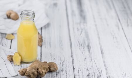 Healthy Ginger Sap on a wooden table as detailed close-up shot (selective focus)の写真素材