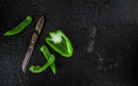 Slate slab with Green paprika (selective focus; close-up shot)の写真素材
