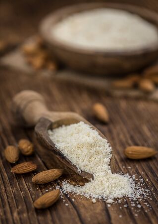 Wooden table with Almond Flour (detailed close-up shot; selective focus)の写真素材