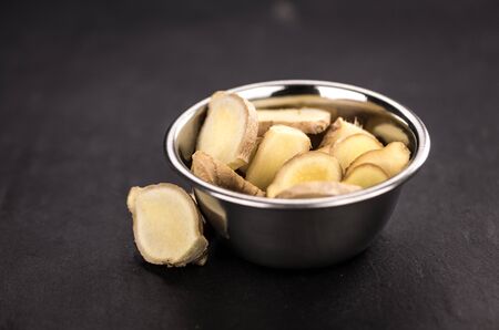 Some fresh Ginger Slices (selective focus; close-up shot)