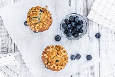 Some fresh Blueberry Muffins (selective focus; close-up shot)