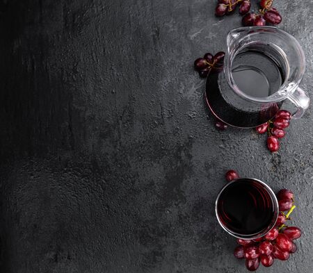 Portion of healthy Red Grape Juice on a slate slab (selective focus)の写真素材