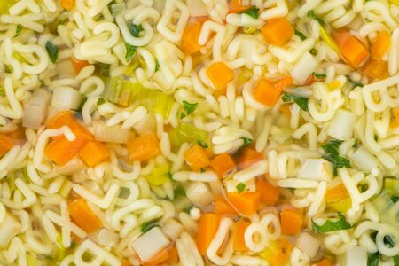 Portion of fresh made Alphabet Soup (selective focus; close-up shot)