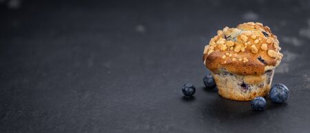 Portion of healthy Blueberry Muffins on a slate slab (selective focus)の写真素材