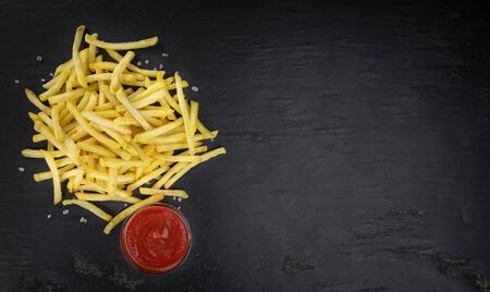 Portion of fresh made crispy French Fries (selective focus; close-up shot)