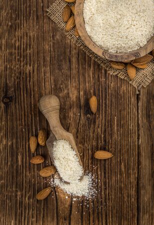 Portion of fresh Powdered Almonds on an old wooden tableの写真素材