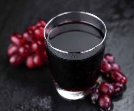 Some fresh Red Grape Juice (selective focus; close-up shot)の写真素材