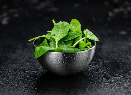 Vintage looking table with fresh Spinach (detailed close-up shot; selective focus)の写真素材