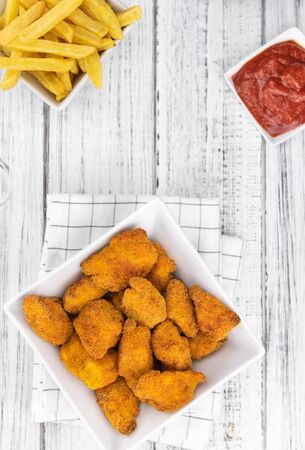 Homemade Chicken Nuggets on vintage background (selective focus; close-up shot)の写真素材