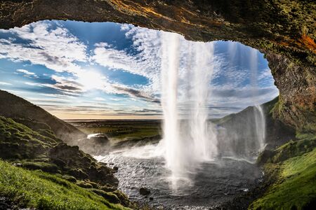 Seljalandsfoss waterfall in south Iceland during a sunsetの写真素材
