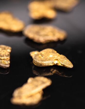 Gold Nuggets on dark background as detailed close up shot, selective focusの写真素材