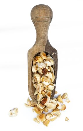 Freshly chopped Hazelnuts as detailed close up shot isolated on white background (selective focus)の写真素材