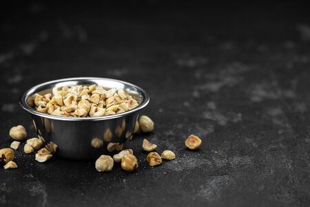 Chopped Hazelnuts on rustic background as close up shot (selective focus)の写真素材