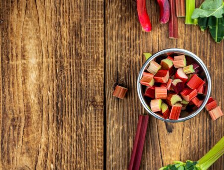 Chopped Rhubarb on an old wooden table (close up shot; selective focus)の写真素材
