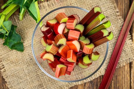 Chopped Rhubarb on an old wooden table (close up shot; selective focus)の写真素材