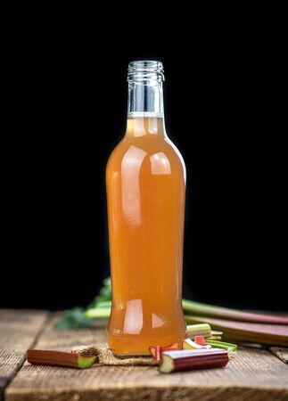 Rhubarb Juice on a rustic background (close up shot; selective focus)の写真素材
