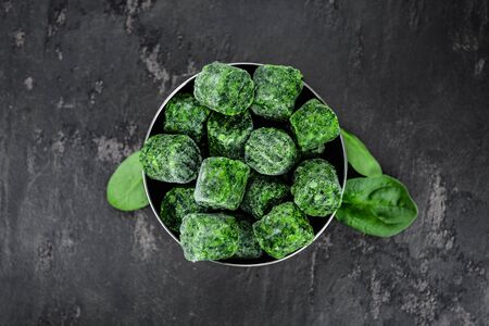 Frozen spinach cubes as detailed close up shot (selective focus)の写真素材