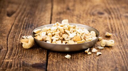Portion of chopped Cashew nuts (close-up shots, selective focus)の写真素材