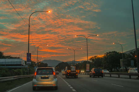 A sunset in a small town south of Kuala Lumpur, with after rush hour traffic jam.の写真素材