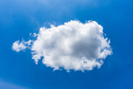 one cumulus cloud in nice blue skyの写真素材