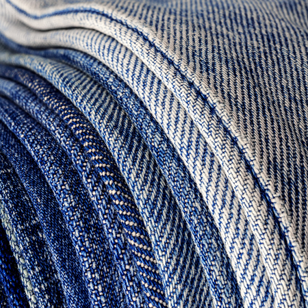 abstract background stack of denim fabric close up jeans texture curve lineの写真素材